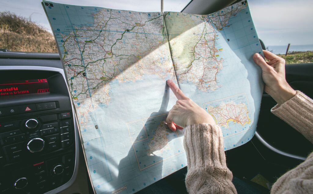looking at a map in a car on a road trip